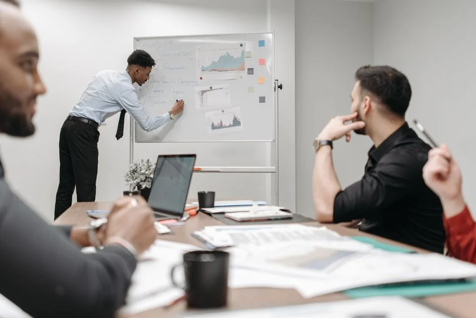 Personne collant un post-it sur un tableau blanc avec les mots Social Media Marketing écrits dessus